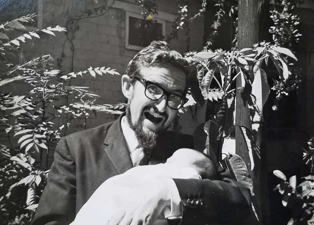 Brian Winder holding one of his sons as a baby